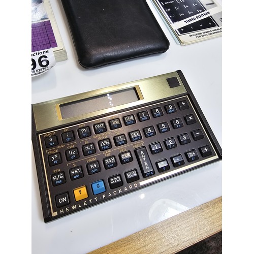 296 - A Hewlett Packard HP-12C business financial calculator in gold and black, complete with its original... 