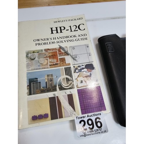 296 - A Hewlett Packard HP-12C business financial calculator in gold and black, complete with its original... 