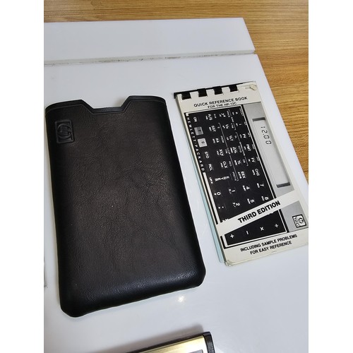 296 - A Hewlett Packard HP-12C business financial calculator in gold and black, complete with its original... 