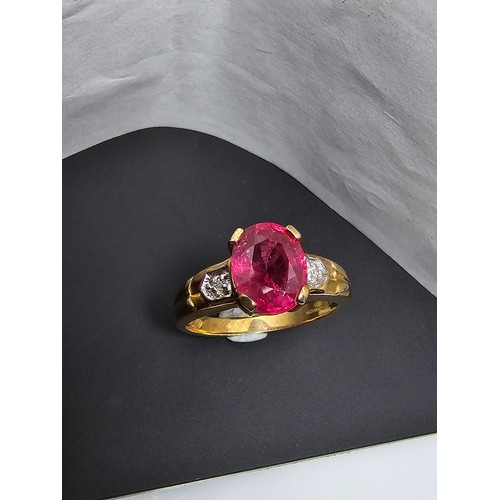 221 - Stunning hallmarked 9ct yellow gold ring inset with a large oval natural ruby faceted gemstone with ... 