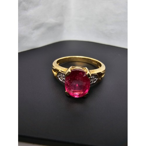 221 - Stunning hallmarked 9ct yellow gold ring inset with a large oval natural ruby faceted gemstone with ... 