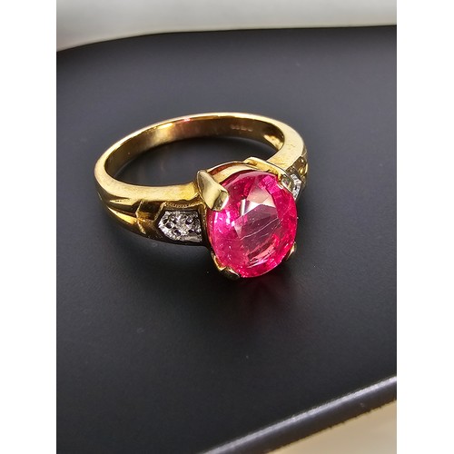 221 - Stunning hallmarked 9ct yellow gold ring inset with a large oval natural ruby faceted gemstone with ... 