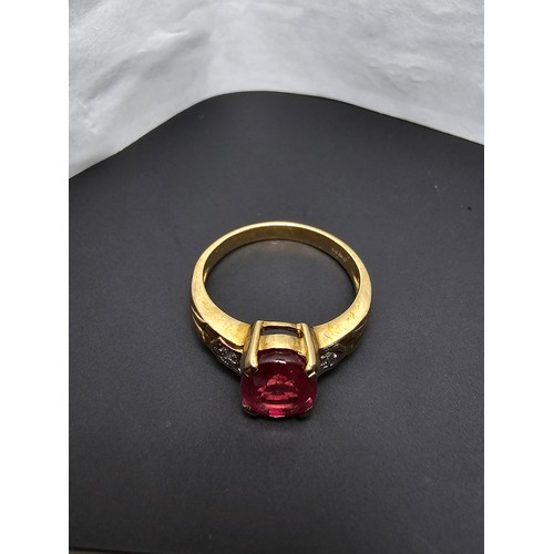 221 - Stunning hallmarked 9ct yellow gold ring inset with a large oval natural ruby faceted gemstone with ... 