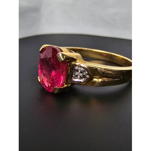 221 - Stunning hallmarked 9ct yellow gold ring inset with a large oval natural ruby faceted gemstone with ... 