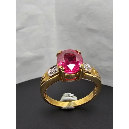 221 - Stunning hallmarked 9ct yellow gold ring inset with a large oval natural ruby faceted gemstone with ... 