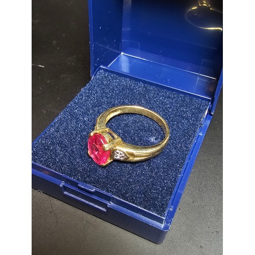 221 - Stunning hallmarked 9ct yellow gold ring inset with a large oval natural ruby faceted gemstone with ... 