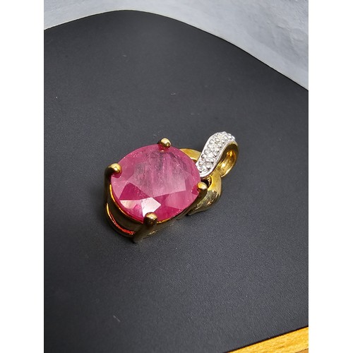 222 - Stunning hallmarked 9ct yellow gold pendant inset with a large oval faceted natural ruby gemstone in... 