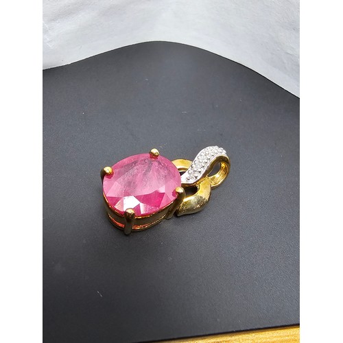 222 - Stunning hallmarked 9ct yellow gold pendant inset with a large oval faceted natural ruby gemstone in... 