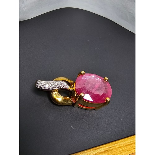 222 - Stunning hallmarked 9ct yellow gold pendant inset with a large oval faceted natural ruby gemstone in... 