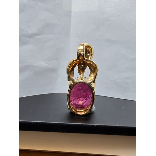 222 - Stunning hallmarked 9ct yellow gold pendant inset with a large oval faceted natural ruby gemstone in... 