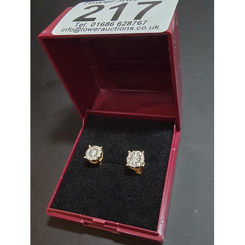 217 - A pair of good quality 14ct yellow gold diamond stud earrings, each earrings is inset with a .064ct ... 