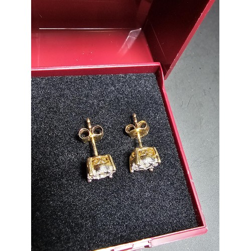 217 - A pair of good quality 14ct yellow gold diamond stud earrings, each earrings is inset with a .064ct ... 