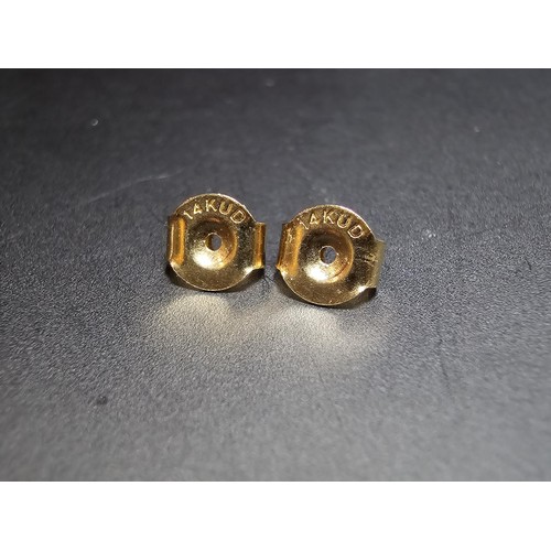 217 - A pair of good quality 14ct yellow gold diamond stud earrings, each earrings is inset with a .064ct ... 