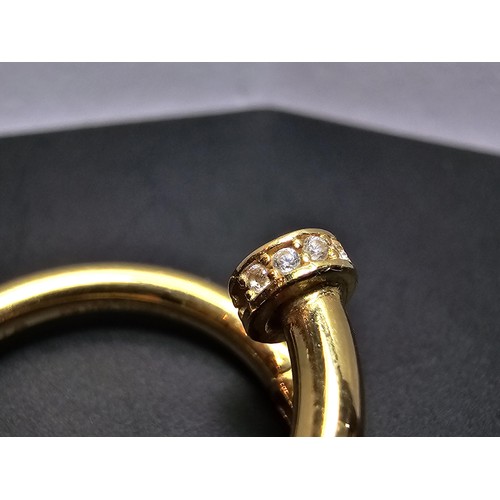 218 - An 18ct yellow gold dress ring in the style of a designer brand inset with sparkly crystal cz stones... 