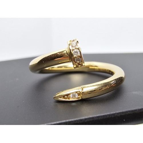 218 - An 18ct yellow gold dress ring in the style of a designer brand inset with sparkly crystal cz stones... 