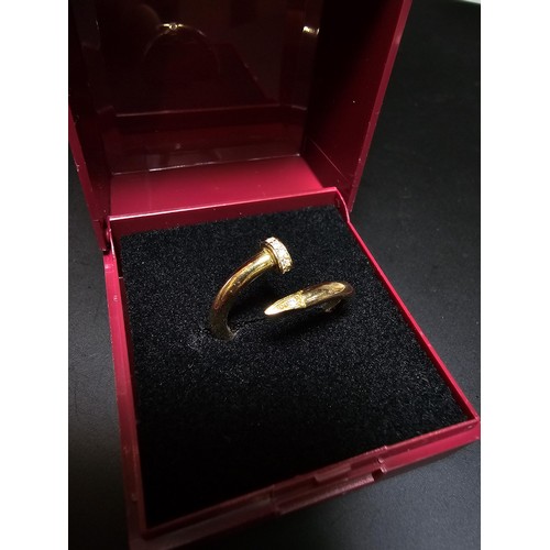 218 - An 18ct yellow gold dress ring in the style of a designer brand inset with sparkly crystal cz stones... 