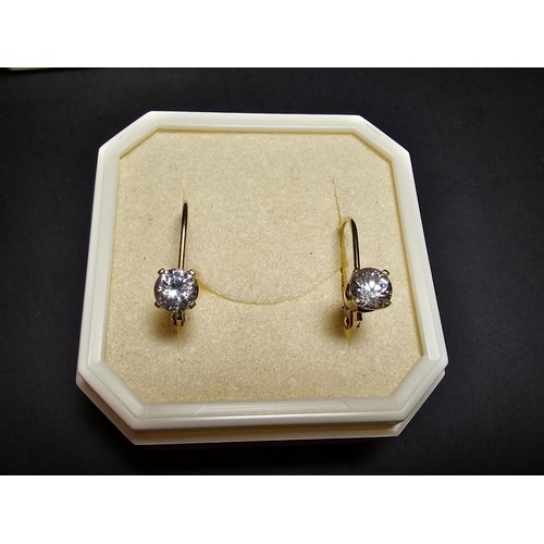 223 - A pair of pretty 14ct yellow gold earrings inset with sparkly crystal cz stones, the earrings appear... 