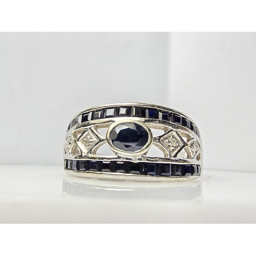 225 - A stunning hallmarked 9ct white gold dress ring inset with a large deep Royal blue sapphire stone to... 