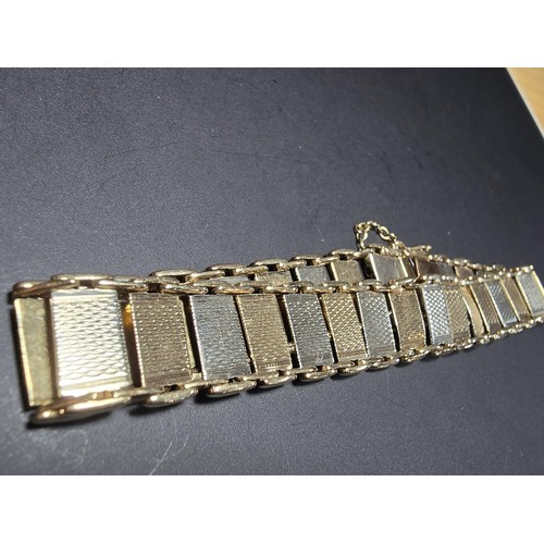 211 - A 9ct tri-colour panel bracelet featuring rose gold, white gold and yellow gold panels, displays ver... 