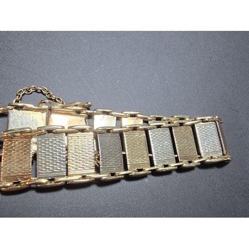 211 - A 9ct tri-colour panel bracelet featuring rose gold, white gold and yellow gold panels, displays ver... 