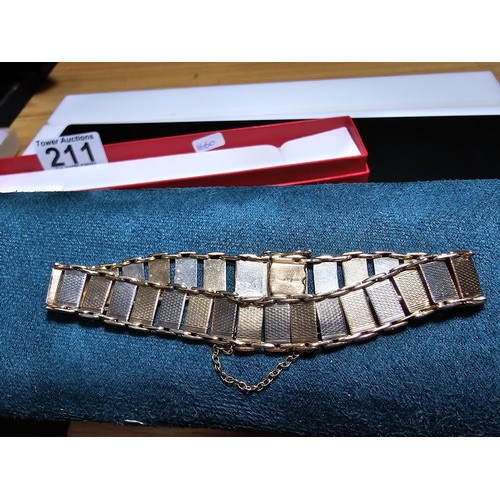 211 - A 9ct tri-colour panel bracelet featuring rose gold, white gold and yellow gold panels, displays ver... 