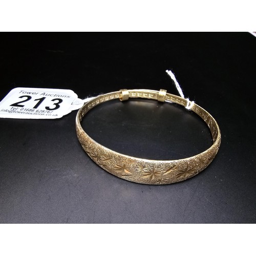 213 - A good quality gold plate on solid 925 sterling silver adjustable bangle, having an engraved star de... 