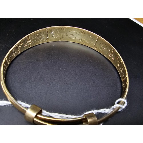 213 - A good quality gold plate on solid 925 sterling silver adjustable bangle, having an engraved star de... 