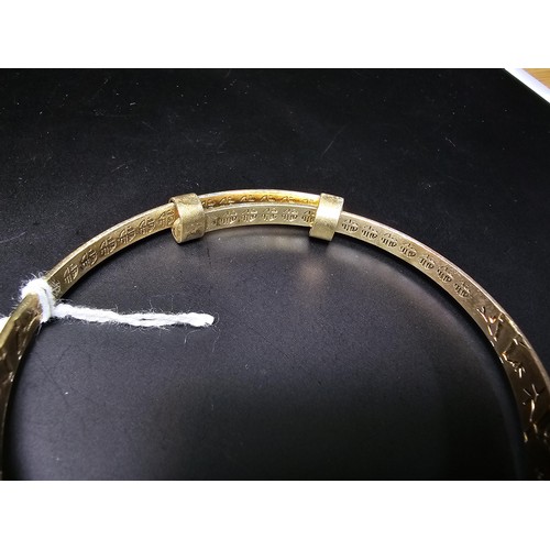 213 - A good quality gold plate on solid 925 sterling silver adjustable bangle, having an engraved star de... 