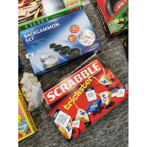 42 - A large quantity of board games to include the Simpsons Scrabble, a vintage Cluedo, table tennis, tr... 