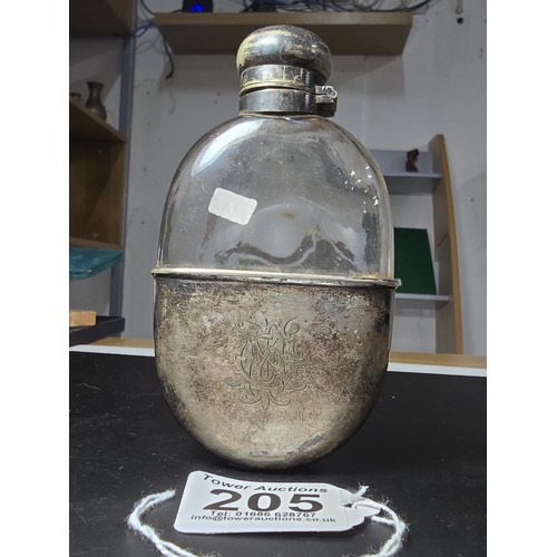 205 - An antique hip flask with a silver plated top and base, in good condition, has a length of 13cm, wit... 