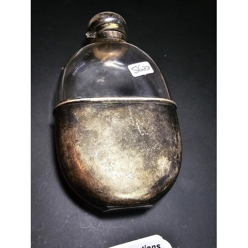 205 - An antique hip flask with a silver plated top and base, in good condition, has a length of 13cm, wit... 