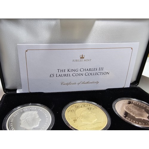 126 - An as new cased Jubilee mint The King Charles III £5 Laurel coin collection, to include three £5 coi... 