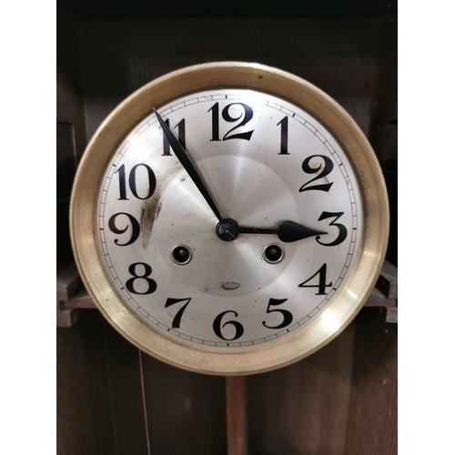 88 - Vintage oak wall clock complete with pendulum and key. Measures 68cm x 33.5cm x 18cm.