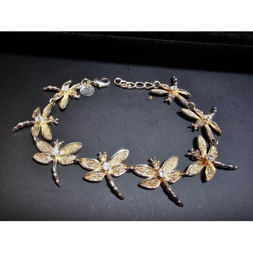 132 - An as new unused 925 silver bracelet with a dragonfly design, each dragonfly is inset with a crystal... 