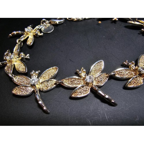 132 - An as new unused 925 silver bracelet with a dragonfly design, each dragonfly is inset with a crystal... 