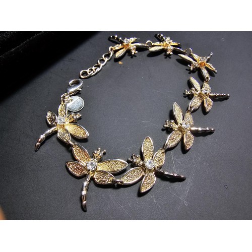 132 - An as new unused 925 silver bracelet with a dragonfly design, each dragonfly is inset with a crystal... 