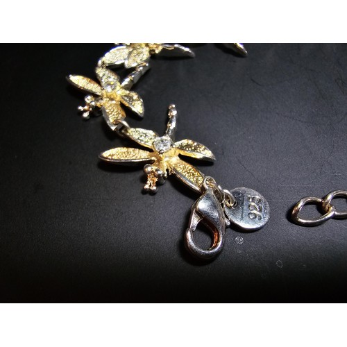 132 - An as new unused 925 silver bracelet with a dragonfly design, each dragonfly is inset with a crystal... 