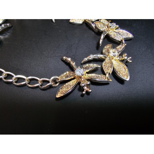 132 - An as new unused 925 silver bracelet with a dragonfly design, each dragonfly is inset with a crystal... 