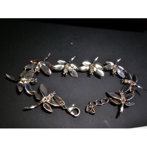 132 - An as new unused 925 silver bracelet with a dragonfly design, each dragonfly is inset with a crystal... 