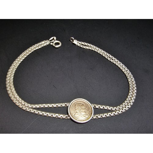 133 - A vintage 925 silver double strand bracelet inset with a real 14ct gold Pope John Paul II coin in ex... 