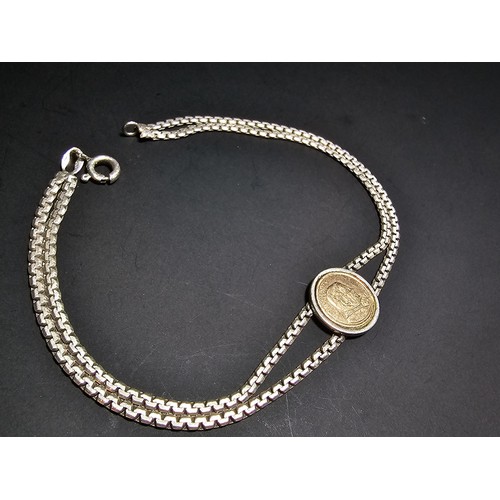 133 - A vintage 925 silver double strand bracelet inset with a real 14ct gold Pope John Paul II coin in ex... 