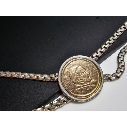 133 - A vintage 925 silver double strand bracelet inset with a real 14ct gold Pope John Paul II coin in ex... 