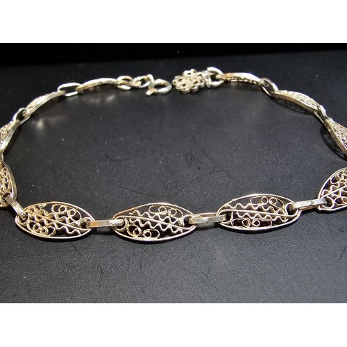 134 - A pretty 900 silver bracelet with a pierced wire work design to each panel, in excellent clean condi... 