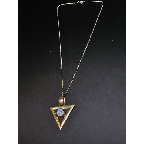 141 - An unusual 925 silver triangular pendant inset with a rainbow moonstone featuring good flashing blue... 