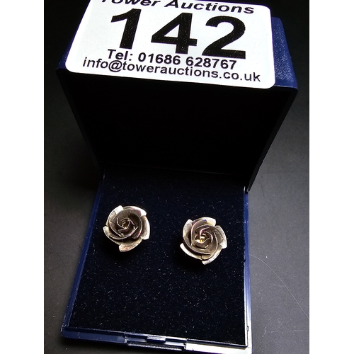 142 - A pretty pair of 925 silver rose and stem formed earrings complete with their butterfly backs. In ex... 