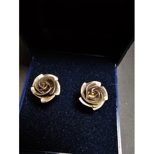 142 - A pretty pair of 925 silver rose and stem formed earrings complete with their butterfly backs. In ex... 