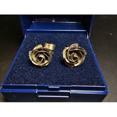 142 - A pretty pair of 925 silver rose and stem formed earrings complete with their butterfly backs. In ex... 