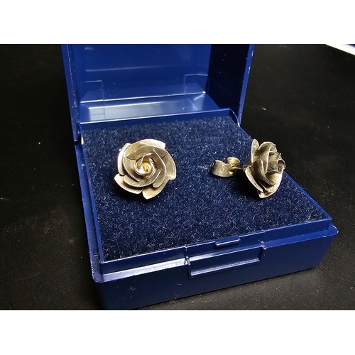 142 - A pretty pair of 925 silver rose and stem formed earrings complete with their butterfly backs. In ex... 