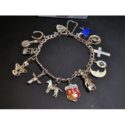 144 - A good 925 silver charm bracelet with 13x different silver charms and 925 silver padlock clasp with ... 