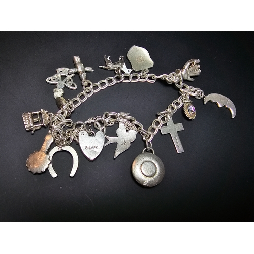 144 - A good 925 silver charm bracelet with 13x different silver charms and 925 silver padlock clasp with ... 